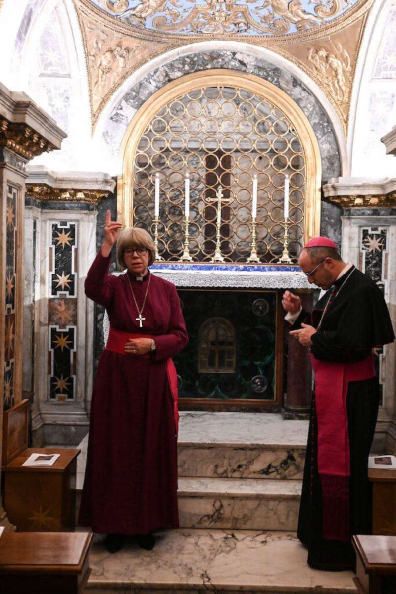 In der Kapelle des Petrusgrabes in den Grotten steht FRau Mullay als Bischof vekleidet und segente feierlich die Anwesenden, neben ihr ein Bischof vom Okumene-Dikasterium, der sich bekreuzigt.